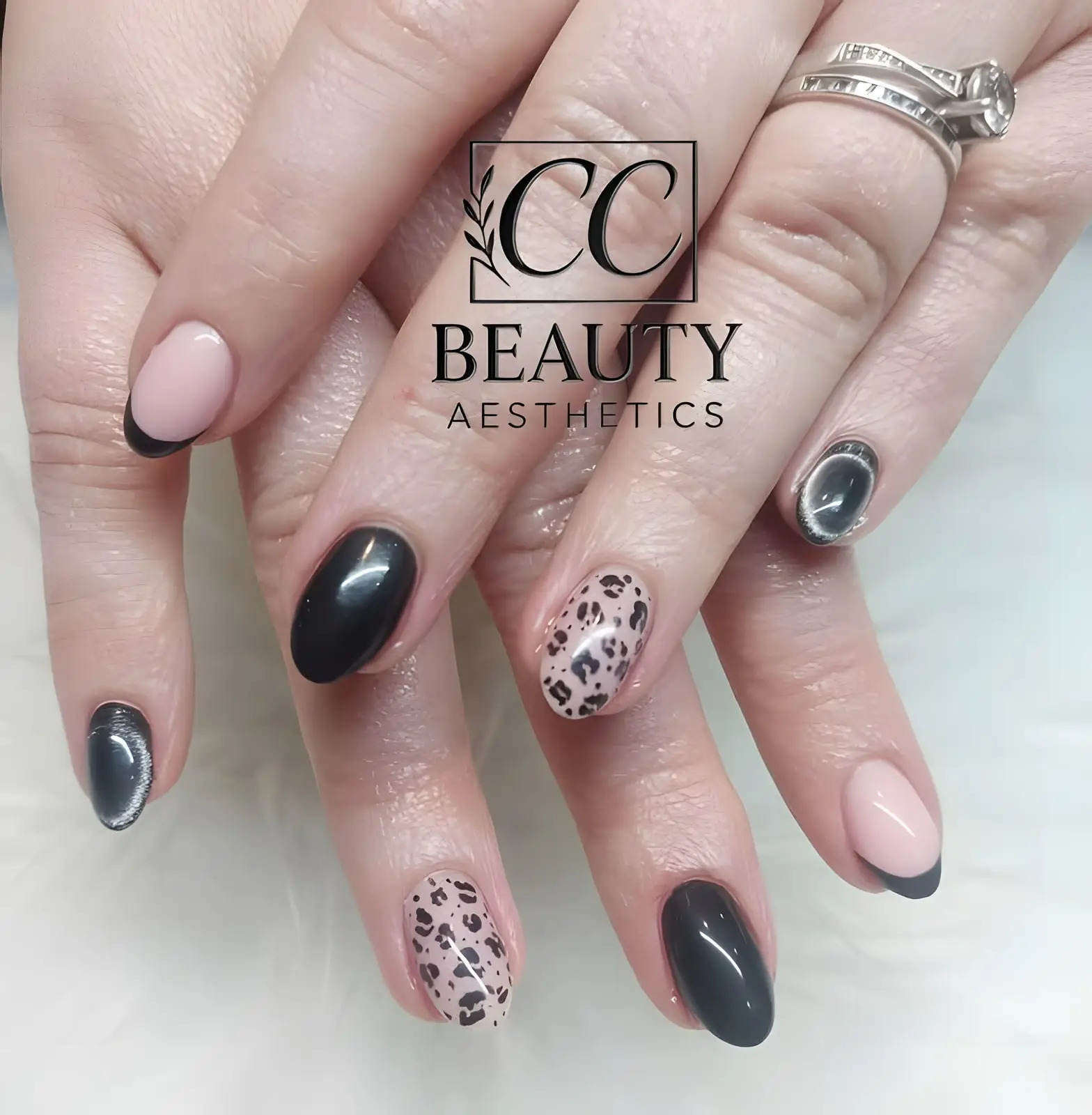 A mix of black, nude with black tips, chrome and leopard-print nails